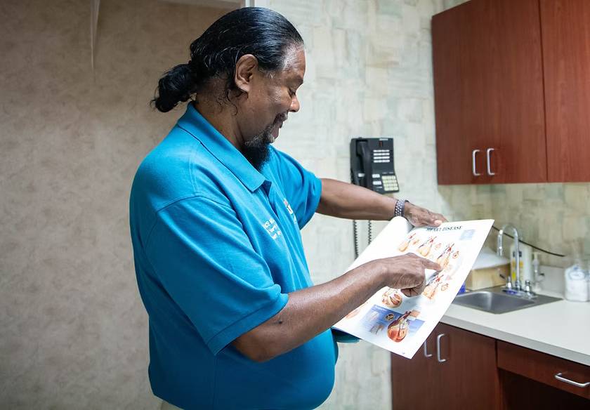 Dr. Aaron France reviewing a chart with a patient