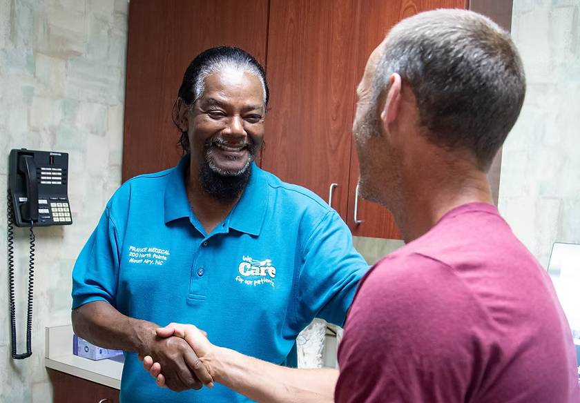Dr. France welcoming a patient